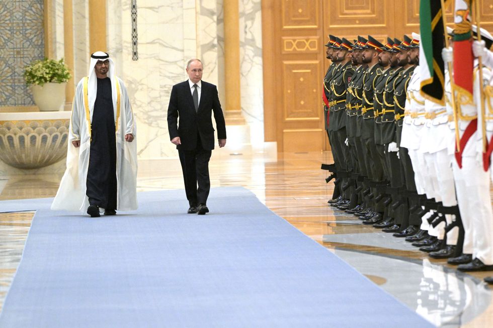 President of the United Arab Emirates Sheikh Mohamed bin Zayed Al Nahyan and Russian President Vladimir Putin walk during a meeting