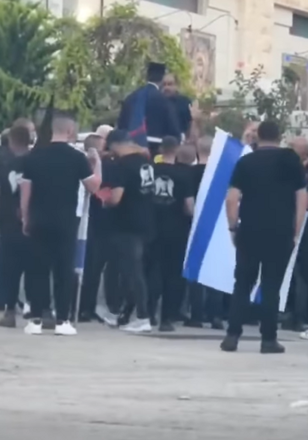 Priest confronting protesters