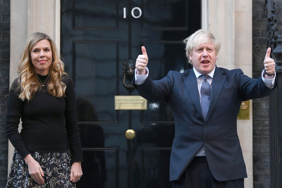 Prime Minister Boris Johnson and his partner Carrie stand in Downing Street in May 2020
