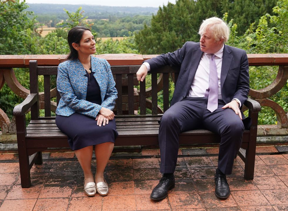 Prime Minister Boris Johnson and Home Secretary Priti Patel speak to cadets during a visit to Surrey Police headquarters in Guildford, Surrey, to coincide with the publication of the government's Beating Crime Plan.