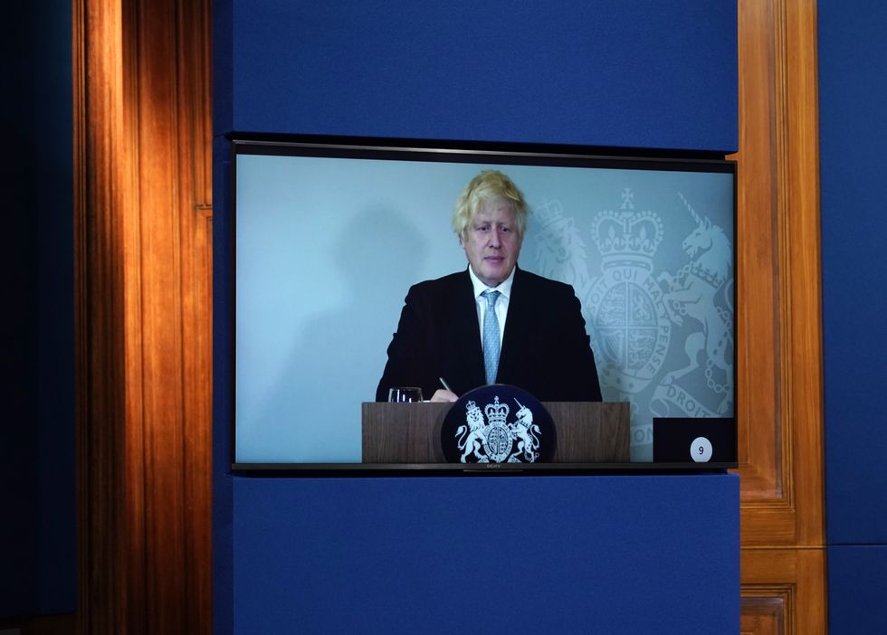 Prime Minister Boris Johnson appears on a screen from Chequers, the country house of the serving UK Prime Minister, where he is self-isolating, during a media briefing in Downing Street, London, on coronavirus (Covid-19). Picture date: Monday July 19, 2021.