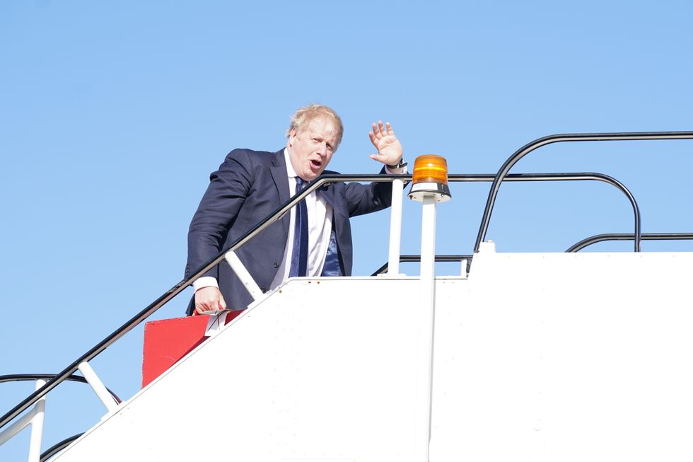 Prime Minister Boris Johnson boards a plane at Stansted Airport as he departs for a visit to India. Picture date: Wednesday April 20, 2022.