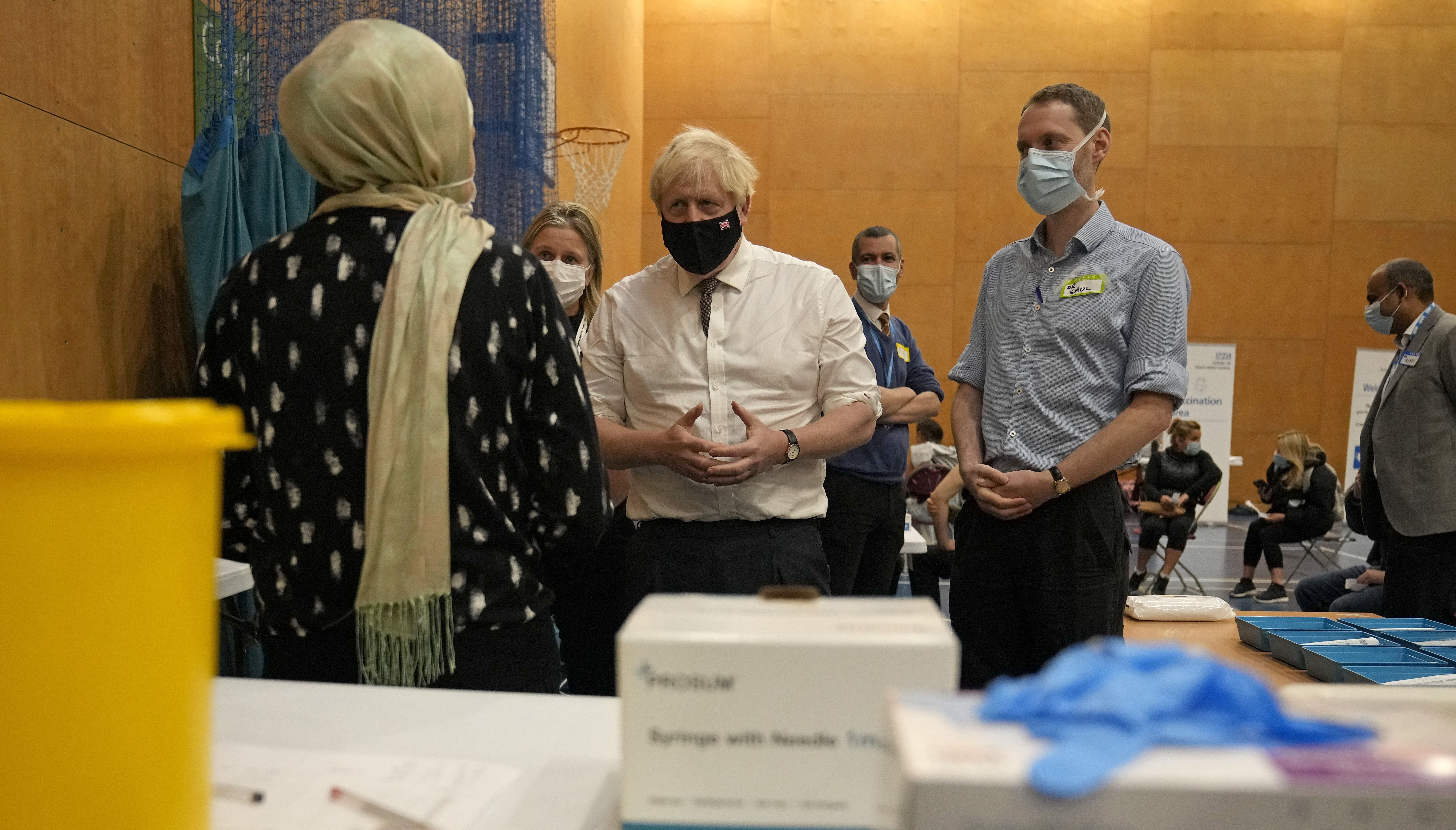 Prime Minister Boris Johnson (centre) speaks to staff during a visit to the Covid-19 vaccine centre at the Little Venice Sports Centre in west London.
