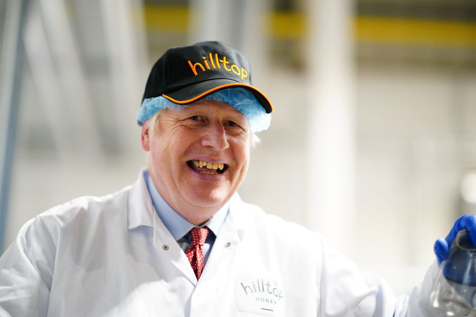 Prime Minister Boris Johnson during a visit to Hilltop Honey in Newtown, Powys, Wales. Picture date: Friday May 20, 2022.
