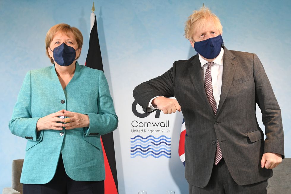 Prime Minister Boris Johnson greets German Chancellor Angela Merkel, ahead of a bilateral meeting during the G7 summit in Cornwall.