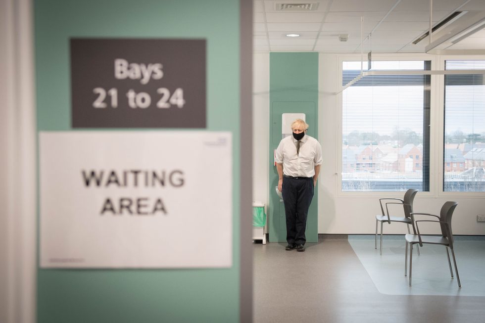 Prime Minister Boris Johnson in the waiting area of Chase Farm Hospital in north London.