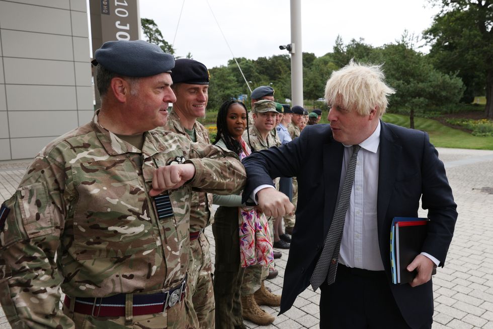 Prime Minister Boris Johnson is greeted by military personnel as he arrives for a visit to Northwood Headquarters, the British Armed Forces Permanent Joint Headquarters, in Eastbury, north west London