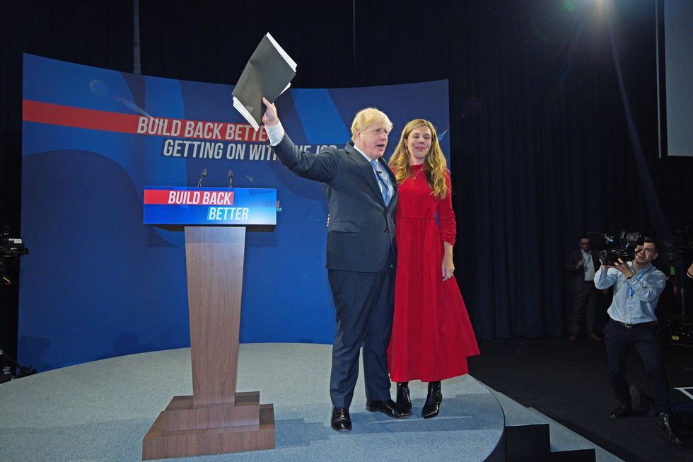 Prime Minister Boris Johnson is joined by his wife Carrie on stage after delivering his keynote speech at the Conservative Party Conference in Manchester.