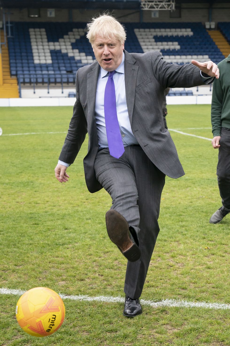Prime Minister Boris Johnson kicks a football during a visit to Bury FC at their ground in Gigg Lane, Bury, Greater Manchester.