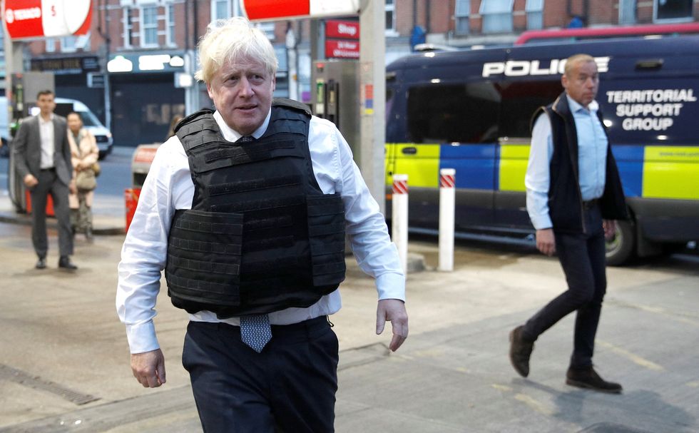 Prime Minister Boris Johnson leaves the area following a drugs related raid by Metropolitan Police officers, in West Norwood, London, as he undertakes visits to meet police recruits and speak to officers working in one of the 20 Violence Reduction Units. Picture date: Wednesday August 31, 2022.