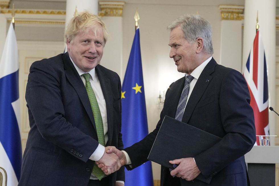 Prime Minister Boris Johnson (left) and Finland's President Sauli Niinisto, shake hands after signing a security assurance at the Presidential Palace in Helsinki, Finland. Picture date: Wednesday May 11, 2022.