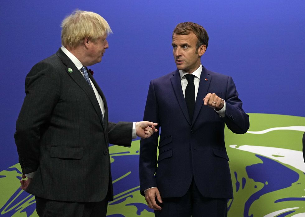 Prime Minister Boris Johnson (left) greets French President Emmanuel Macron at the Cop26 summit.