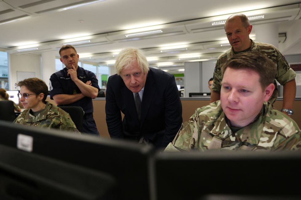 Prime Minister Boris Johnson observes the operations room for the Afghan Relocation and Assistance Policy during a visit to Northwood Headquarters, the British Armed Forces Permanent Joint Headquarters, in Eastbury, north west London, where he met with personnel working on the UK operation in Afghanistan. Picture date: Thursday August 26, 2021.