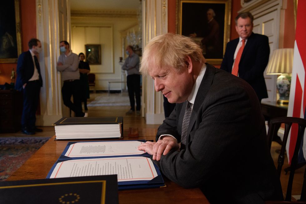 Prime Minister Boris Johnson poses for photographs after signing the Trade and Cooperation Agreement between the UK and the EU, the Brexit trade deal