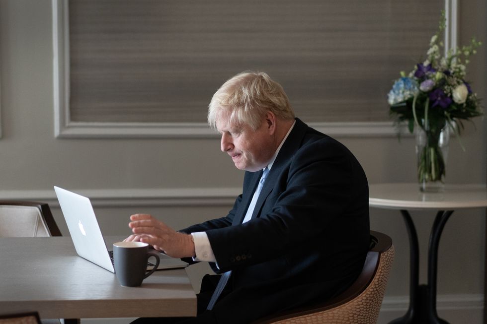 Prime Minister Boris Johnson prepares his keynote speech in his hotel room in Manchester before addressing the Conservative Party Conference on Wednesday. Picture date: Tuesday October 5, 2021.