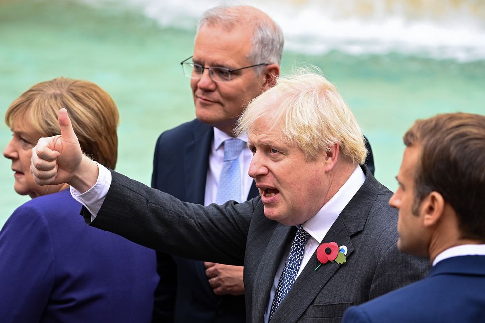 Prime Minister Boris Johnson Prime Minister Boris Johnson gives a thumbs up as he stands with Chancellor of Germany, Angela Merkel Prime Minister of Australia, Scott Morrison and French President Emmanuel Macron as they join G20 leaders during a visit to the Trevi fountain in Rome, Italy during the G20 summit.
