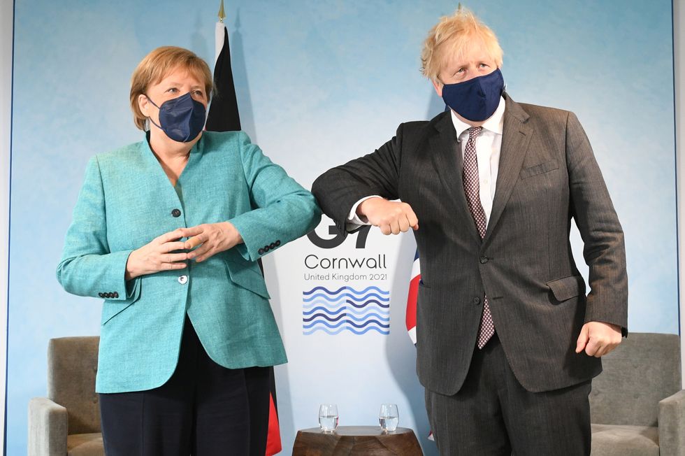 Prime Minister Boris Johnson (right) greets German Chancellor Angela Merkel, ahead of a bilateral meeting during the G7 summit in Cornwall. Picture date: Saturday June 12, 2021.