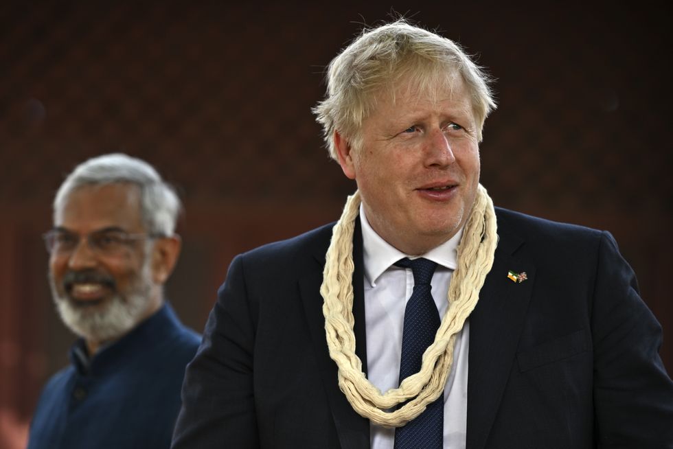 Prime Minister Boris Johnson (right) wearing a garland as India's environmental educator Kartikeya Sarabhai watches, at Mahatma Gandhi's Sabarmati Ashram in Ahmedabad during a cultural tour as part of his two day visit to India. Picture date: Wednesday April 20, 2022.