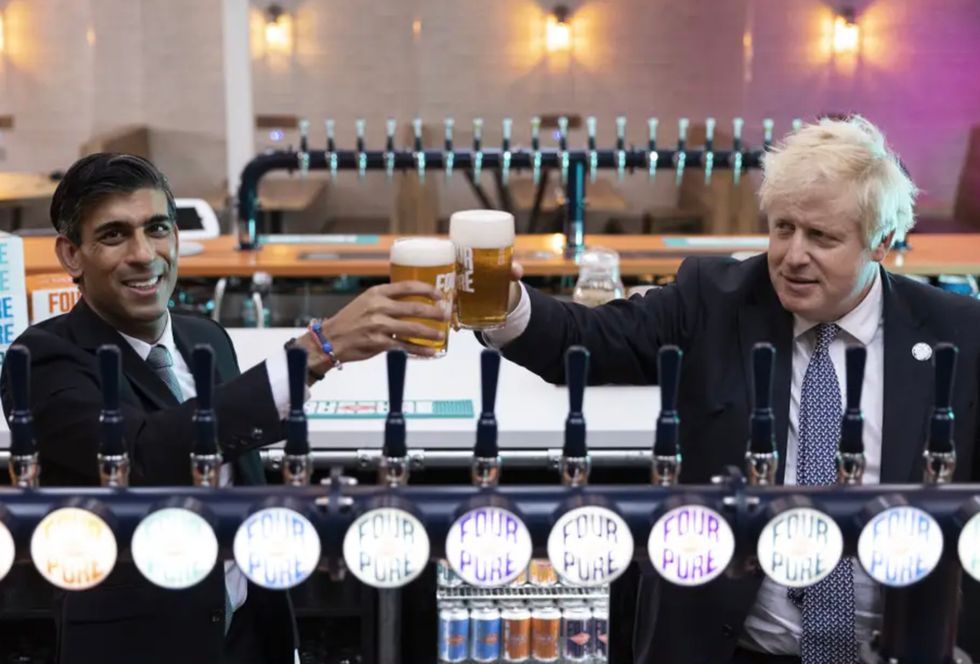 Prime Minister Boris Johnson (right) with Chancellor of the Exchequer Rishi Sunak during a visit to Fourpure Brewery in Bermondsey, London