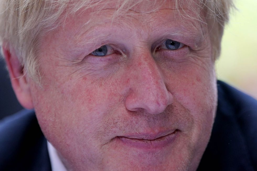 Prime Minister Boris Johnson speaks with stallholders during an event to promote British businesses, at Downing Street, London