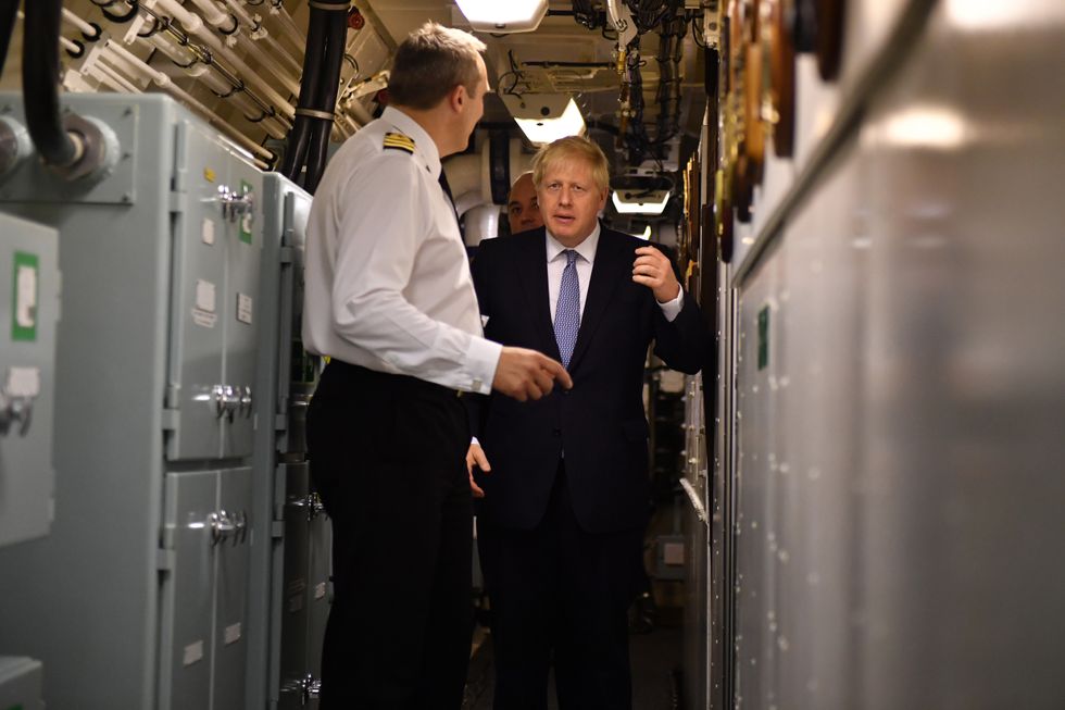 Prime Minister Boris Johnson visits HMS Victorious accompanied by Commander Justin Codd at HM Naval Base Clyde in Faslane, Scotland in 2019.
