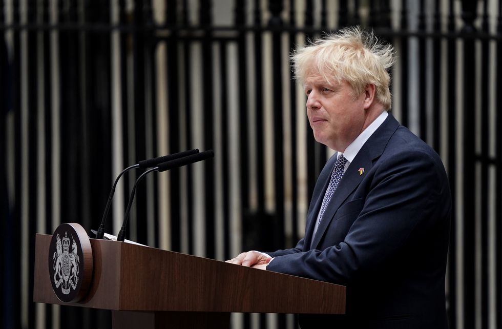 Prime Minister Boris Johnson, watched by wife Carrie Johnson (centre holding daughter Romy), reads a statement outside 10 Downing Street, London, formally resigning as Conservative Party leader after ministers and MPs made clear his position was untenable. He will remain as Prime Minister until a successor is in place. Picture date: Thursday July 7, 2022.