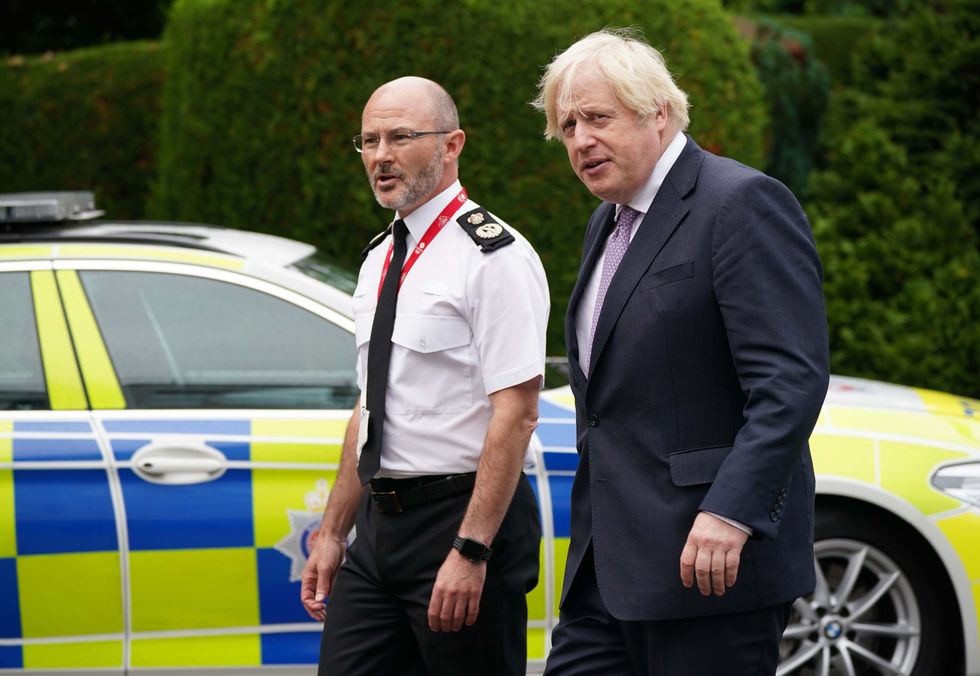 Prime Minister Boris Johnson with Chief Constable Gavin Stephens (left) during a visit to Surrey Police headquarters in Guildford, Surrey