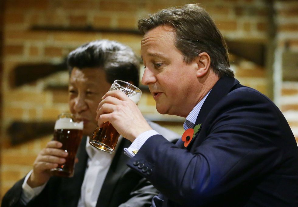 Prime Minister David Cameron drinks a pint with Chinese President Xi Jinping at The Plough Inn at Cadsden in Princes Risborough