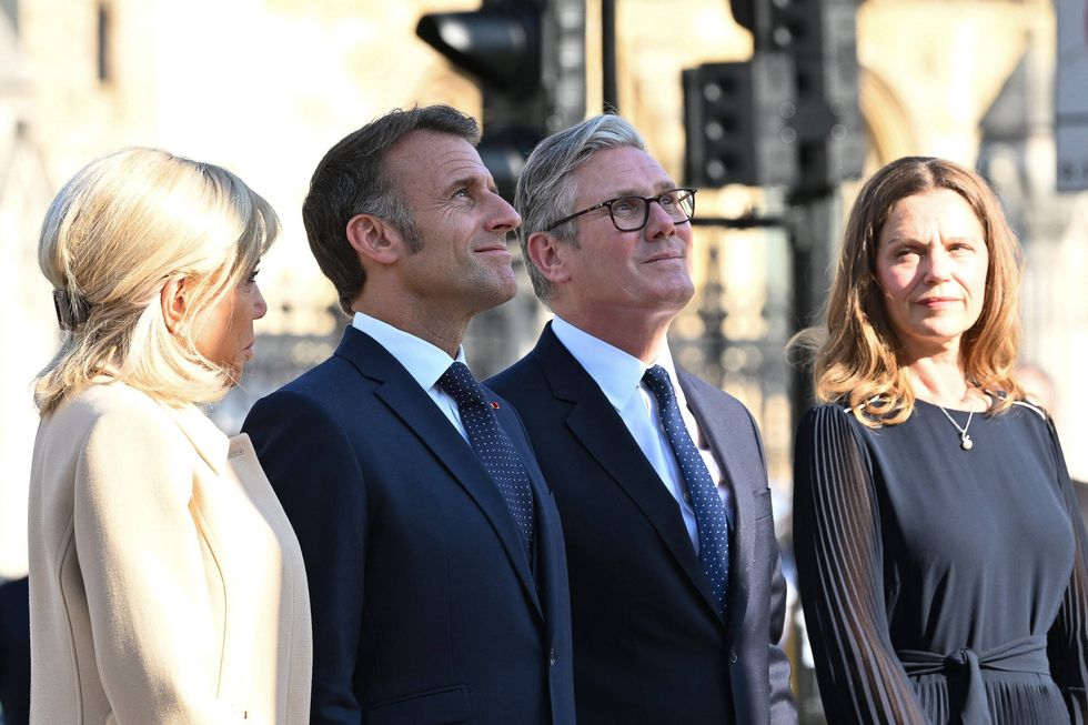 Prime Minister Keir Starmer (3L) and his wife Victoria Starmer, alongside France's President Emmanuel Macron (2L) and his wife Brigitte Macron (L) attend a ceremony at the statue of war-time Prime Minister Winston Churchill