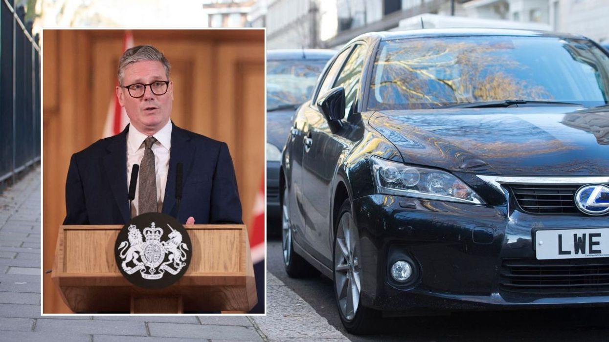 Prime Minister Keir Starmer and a row of parked cars