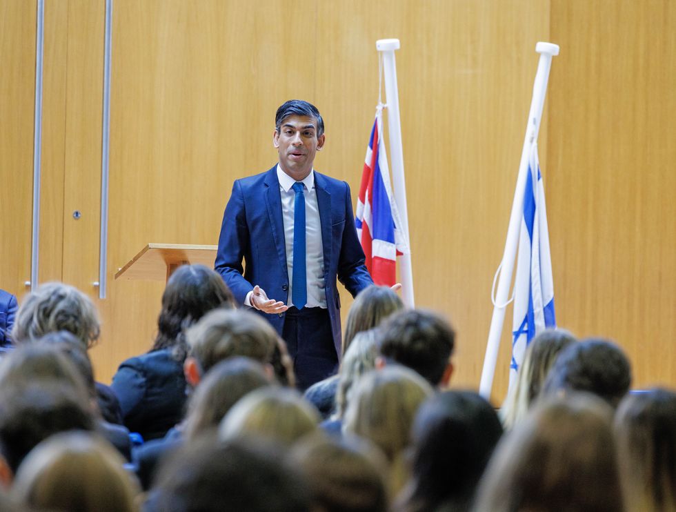 Prime Minister Rishi Sunak addressing an assembly during a visit to a school in north London