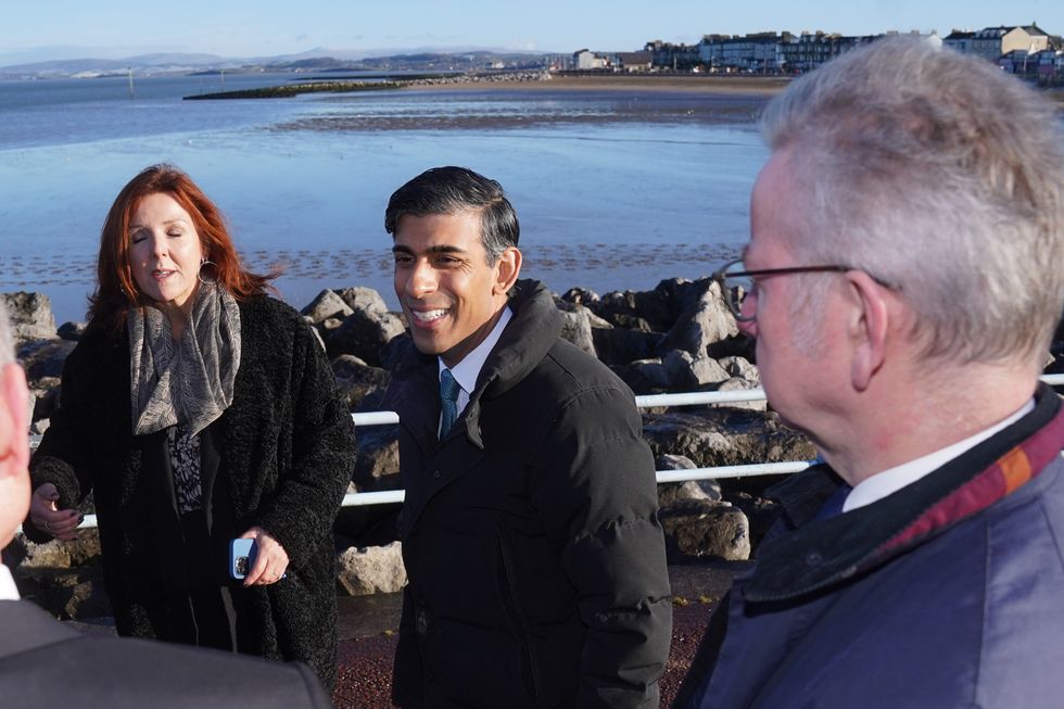 Prime Minister Rishi Sunak (centre) and Minister for Levelling Up, Housing and Communities, Michael Gove, during a community visit to the Eden Project North in Morecambe, Lancashire. Mr Sunak has reiterated his commitment to levelling up as the Government announced 2 billion for more than 100 projects across the UK. Among the projects earmarked for funding is the Eden Project North in Morecambe, which received 50 million for the regeneration project designed to transform the Lancashire town's seafront. Picture date: Thursday January 19, 2023.