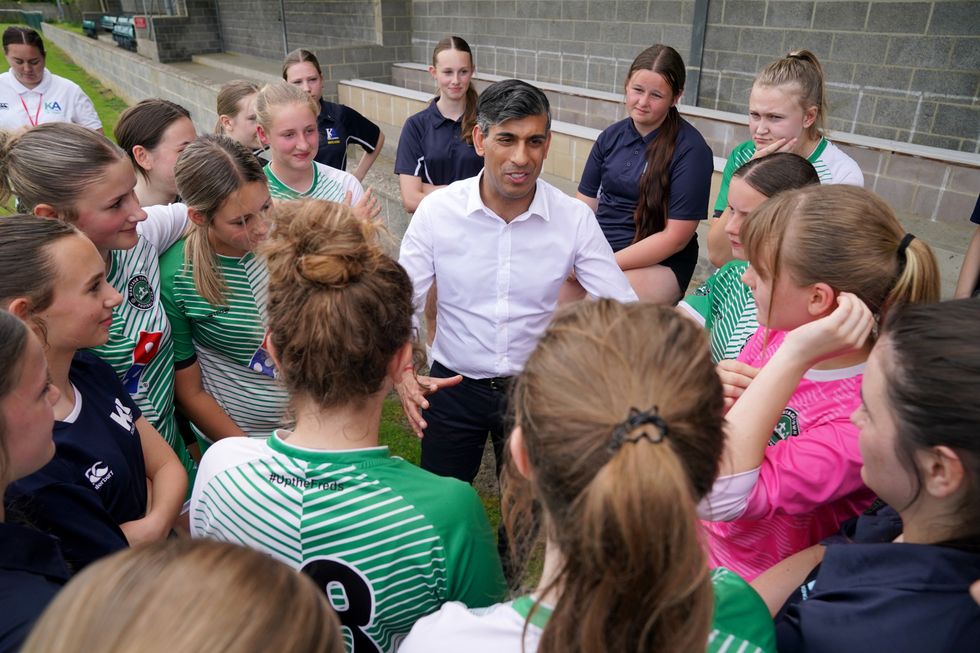 Prime Minister Rishi Sunak (centre) speaks to members of Wantage Town Football Club during a visit to the club in Oxfordshire