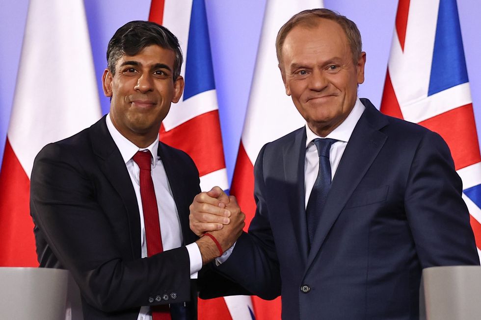 Prime Minister Rishi Sunak (left) and Polish Prime Minister Donald Tusk shake hands