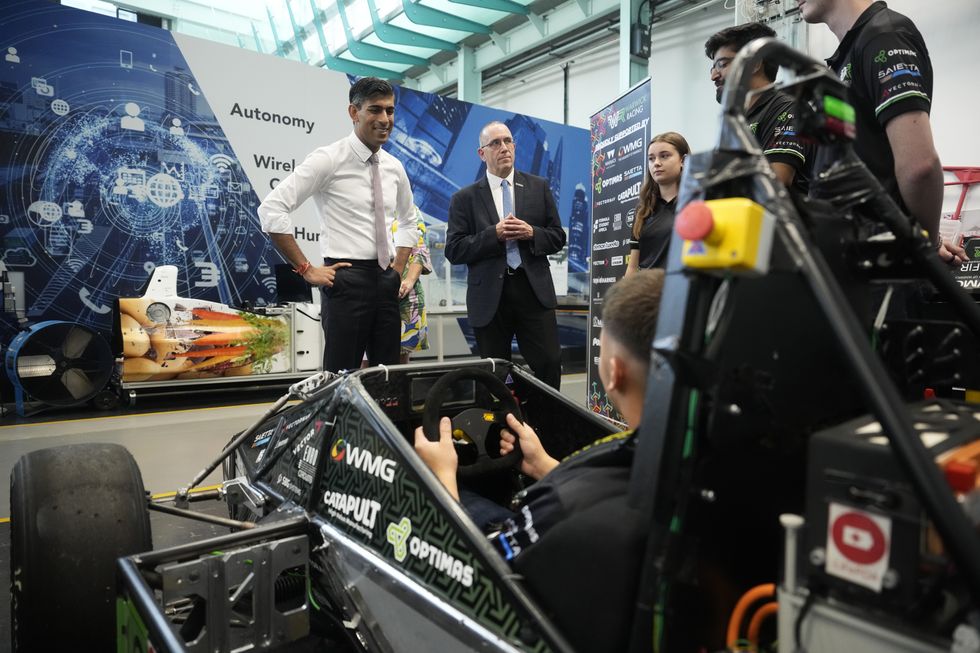 Prime Minister Rishi Sunak (left) views the build of an electric racing car and talks with the student racing team during a visit to a science event at the International Manufacturing Centre at the at University of Warwick
