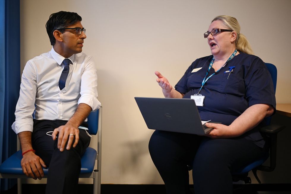 Prime Minister Rishi Sunak listens to Donna Pereira as he meets with a multi-disciplinary team who provide virtual care during a visit to the Rutland Lodge Healthcare Centre in Leeds. Picture date: Monday January 9, 2023.