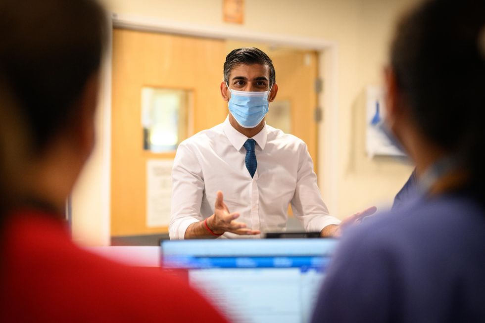 Prime Minister Rishi Sunak speaks with members of staff during a visit to Croydon University Hospital, south London. Picture date: Friday October 28, 2022.