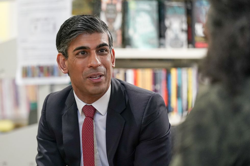 Prime Minister Rishi Sunak speaks with parents and teachers as he visits Haughton Academy in Darlington