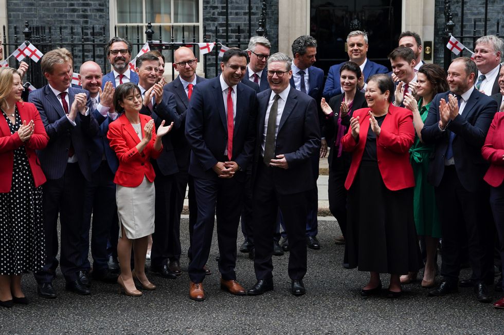 Prime Minister Sir Keir Starmer (centre right) and Scottish Labour leader Anas Sarwar (centre left) pose for a photograph with the new intake of Scottish Labour MPs