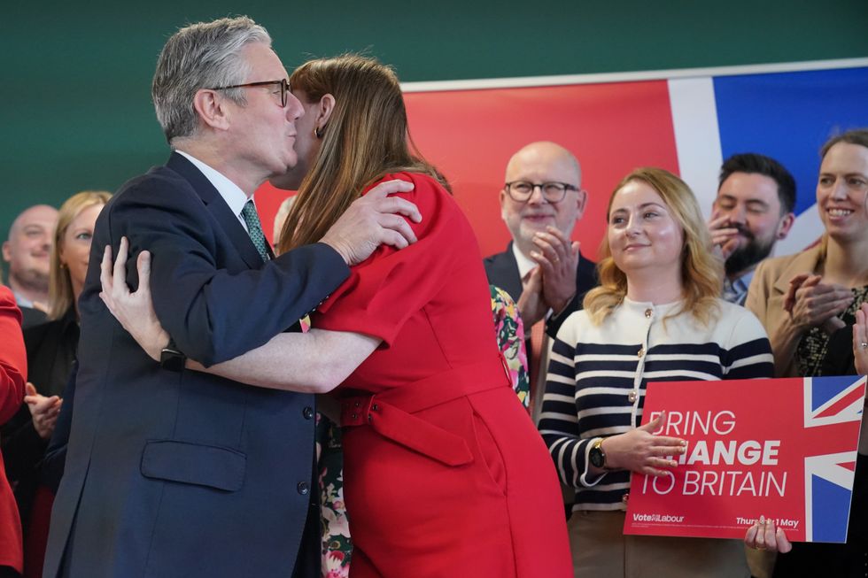 Prime Minister Sir Keir Starmer, is embraced by Deputy Prime Minister Angela Rayner prior to speaking at a distribution centre for Peak Pharmacy, in Chesterfield, Derbyshire