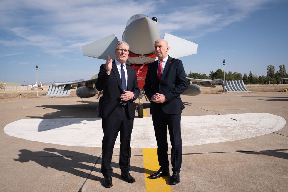 Prime Minister Sir Keir Starmer (left) and Defence Secretary John Healey stand in front of a UK Typhoon fighter jet