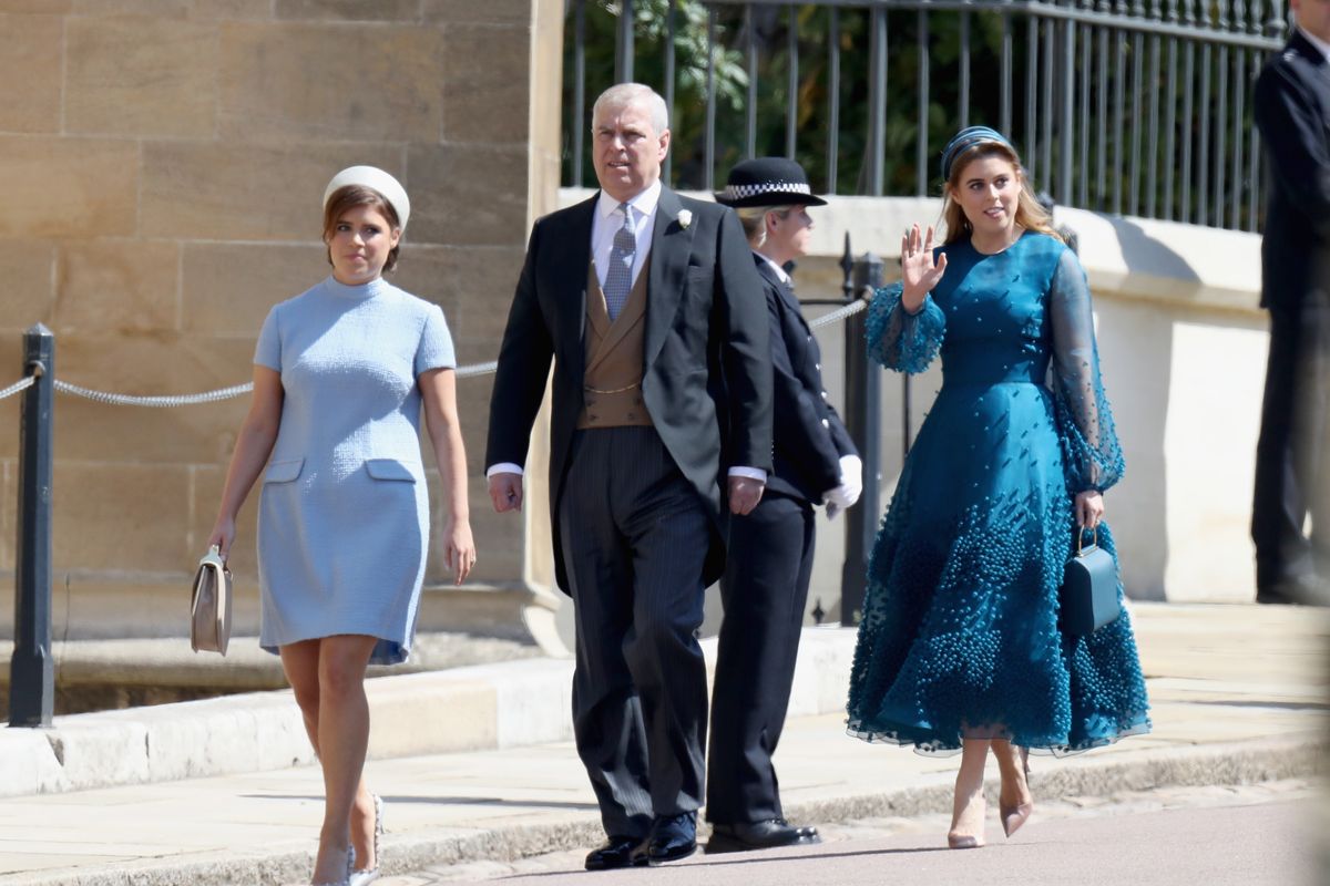 Prince Andrew walks alongside his daughters Princess Beatrice and Princess Eugenie
