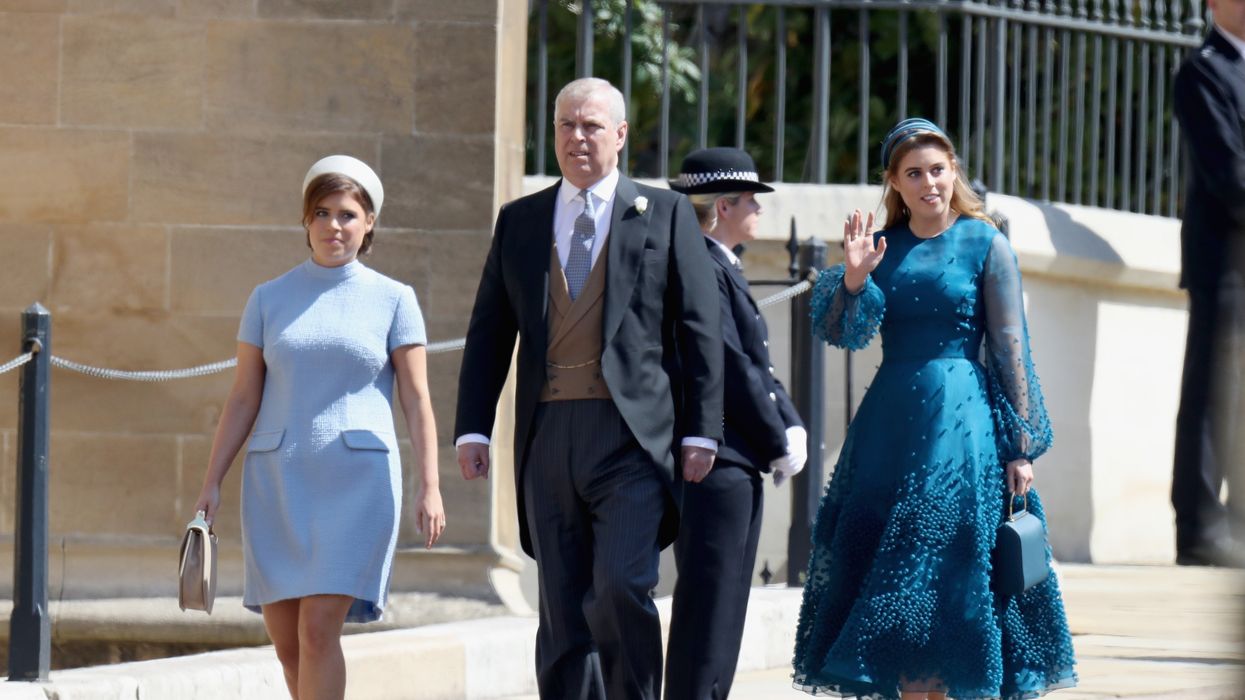 Prince Andrew walks alongside his daughters Princess Beatrice and Princess Eugenie