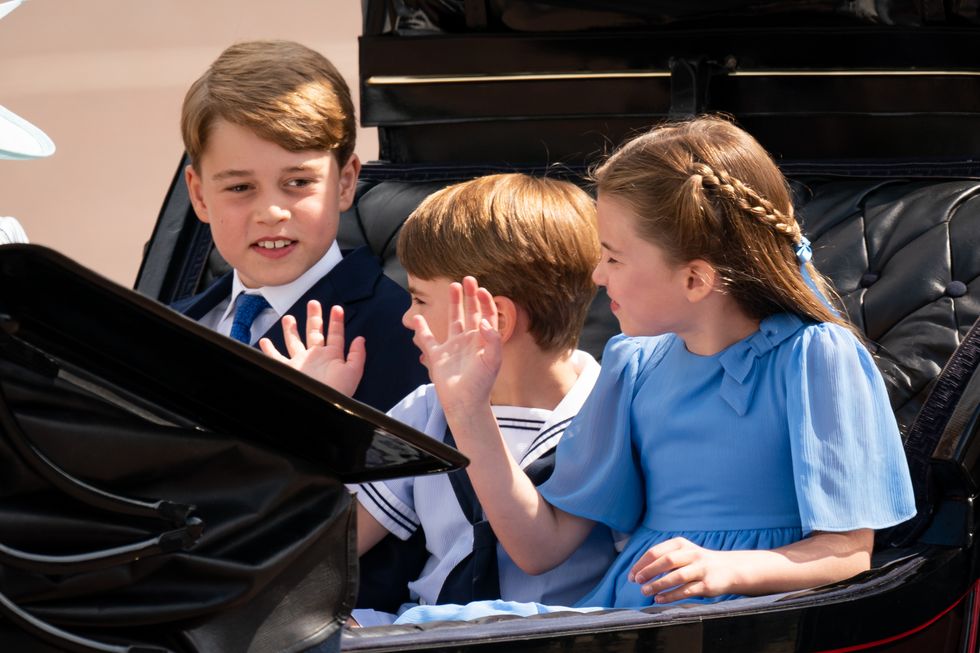 Prince George, Prince Louis and Princess Charlotte ride in a carriage as the Royal Procession leaves Buckingham Palace for the Trooping the Colour ceremony at Horse Guards Parade, central London