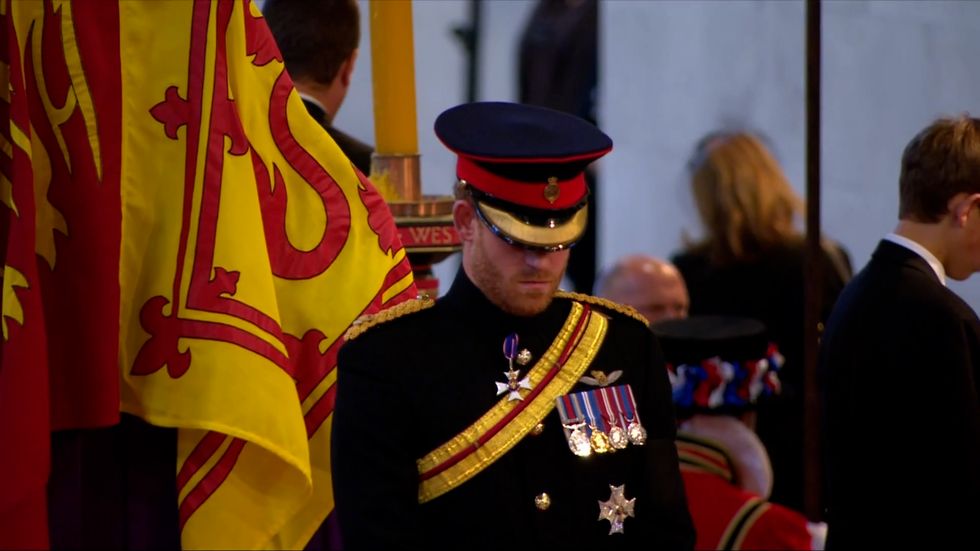 Prince Harry had his head bowed as members of the public filed past.