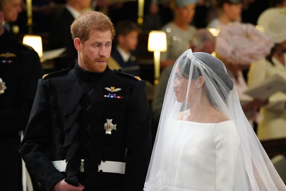 Prince Harry looks at his bride, Meghan Markle, as she arrives at their wedding