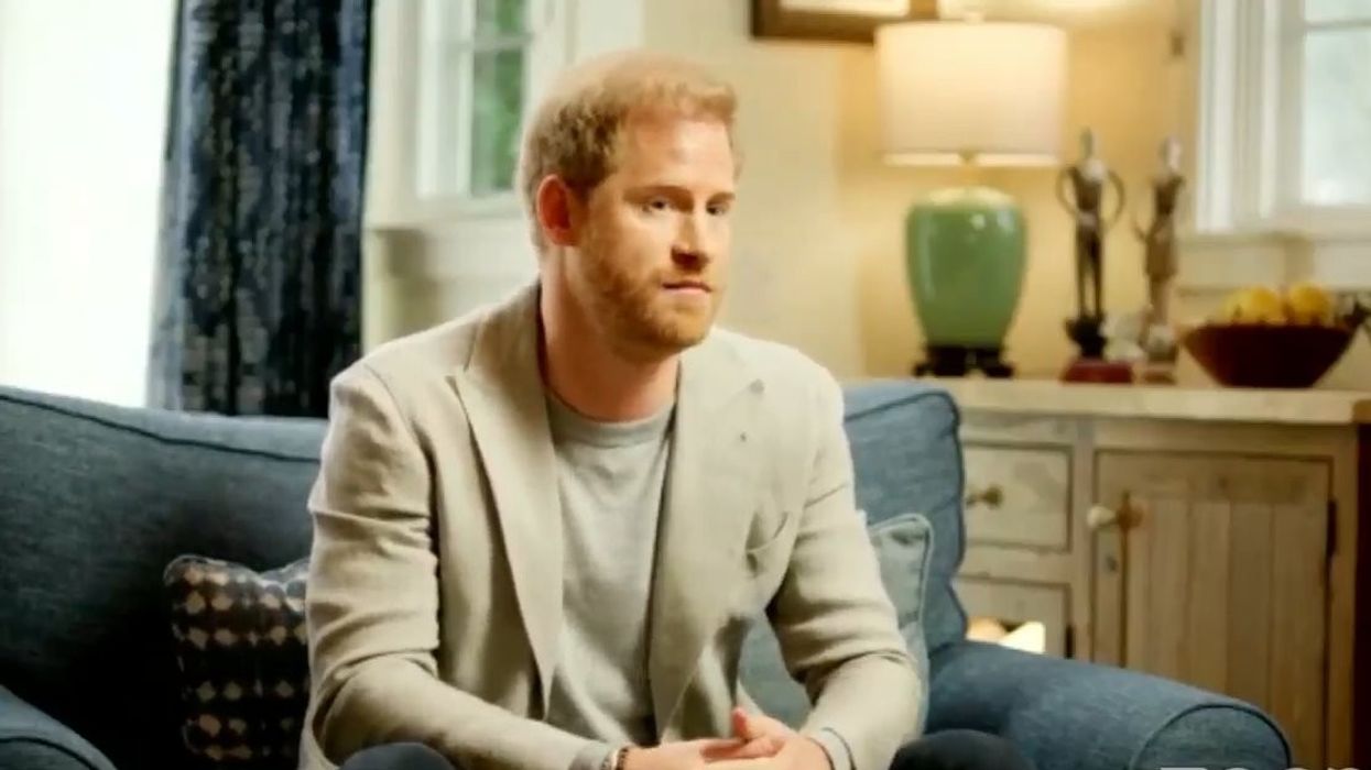 Prince Harry sat on a sofa being interviewed