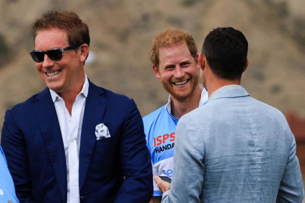 Prince Harry speaks with an attendee at the ISPS Handa Polo Cup