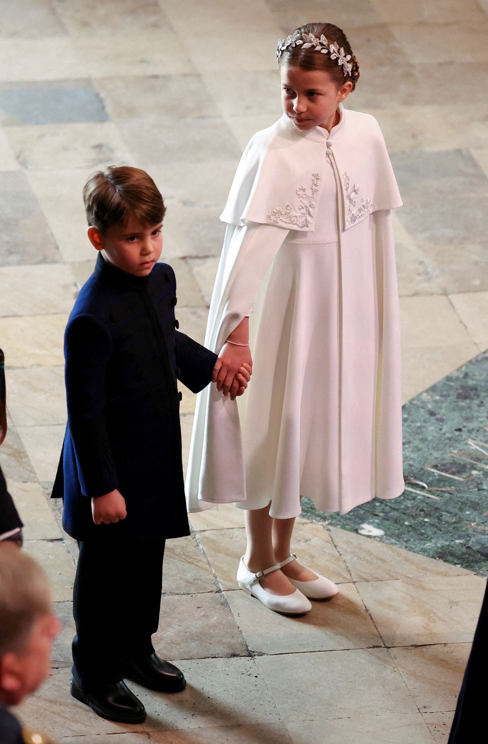 Prince Louis (left) holding hands with Princess Charlotte (right) at Westminster Abbey