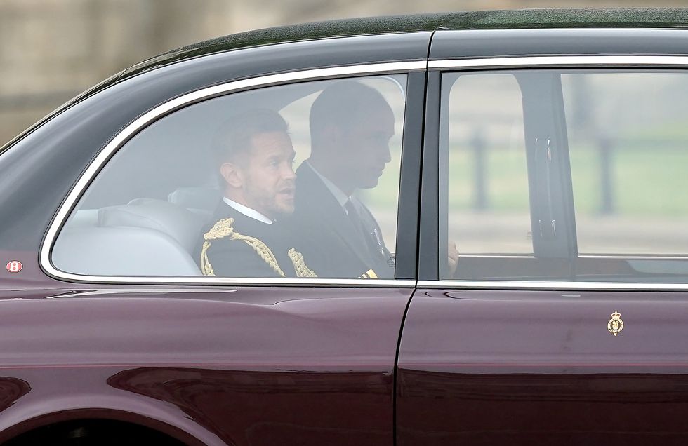 Prince William (far side) leaves Buckingham Palace as he heads to the State Opening of Parliament